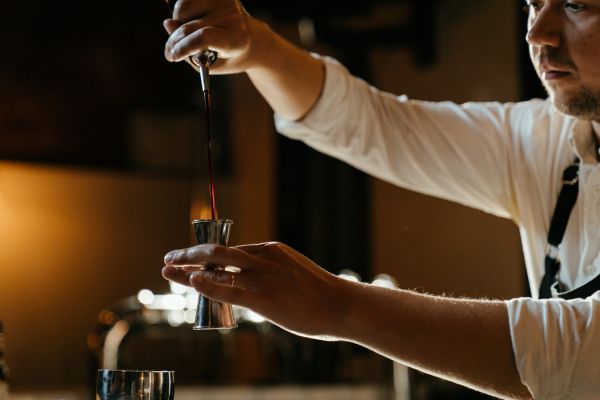 A bartender pouring a drink at an event