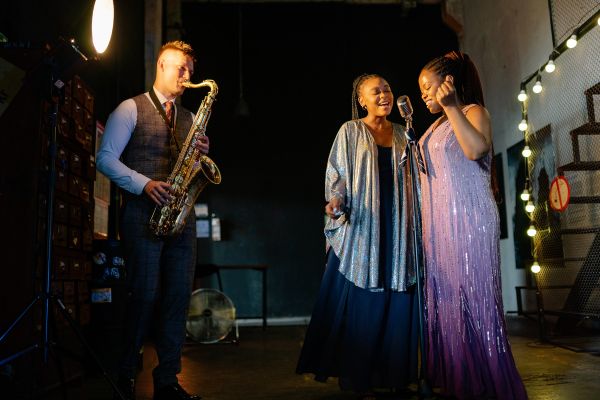 Singers and a saxophone player in a band