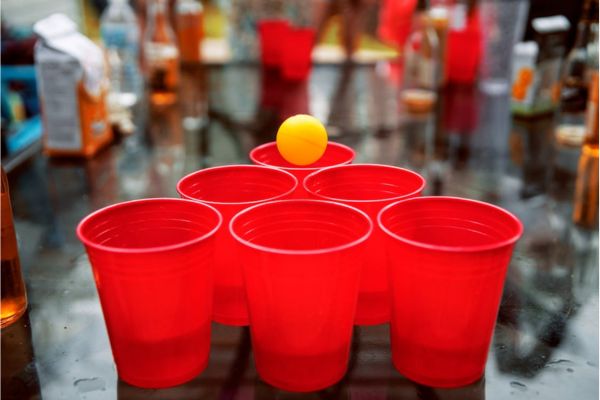 Drinking game of beer pong with cups