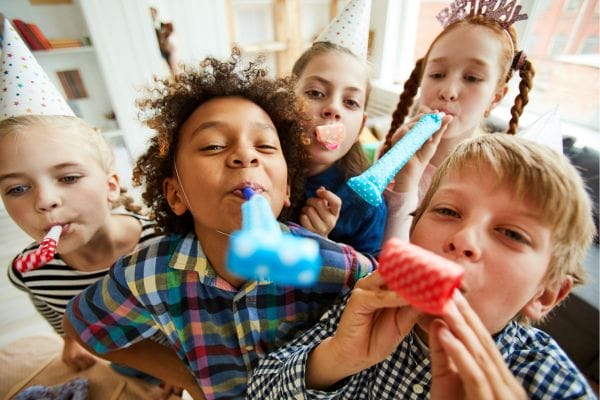 A group of kids with birthday blowers