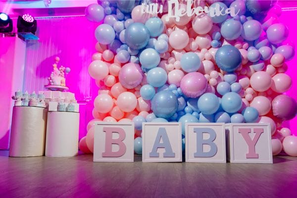 A boy and girl decorated gender reveal setup