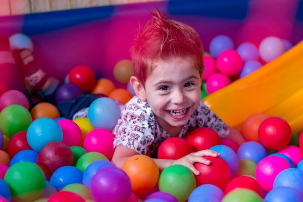 A child in a ball pit playing
