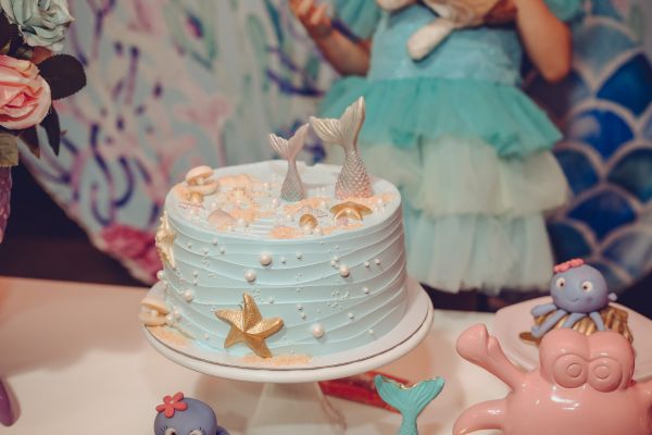 An under-the-sea-themed cake with dolphin tails