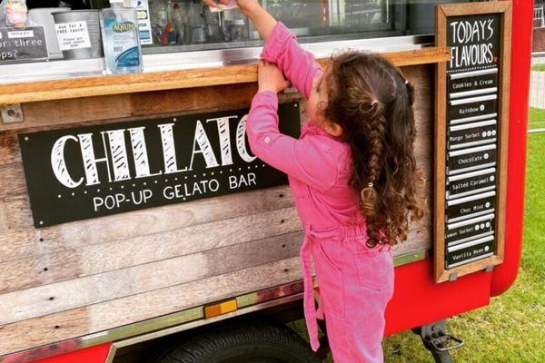 A little customer reaching for her ice cream at the Chillato truck
