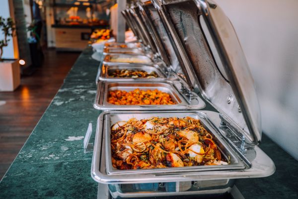 A series of buffets food warmers open for serving