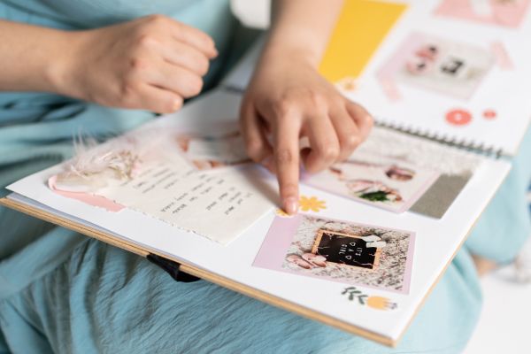 A bride-to-be creating a mood board in a scrapbook,