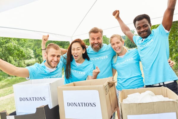 People holding donations boxes for a fundraising event