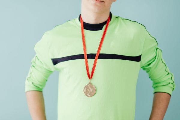 A boy with a medal around his neck
