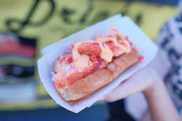 A lobster roll being held up