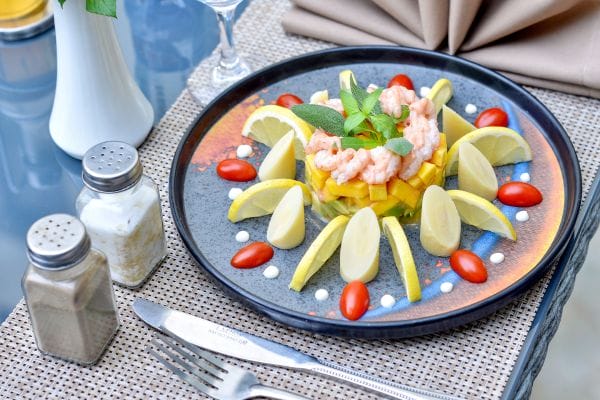 A plate with prawns and mango salad